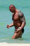 batista side poses and arm tattoo